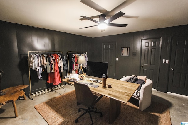 office with concrete floors and ceiling fan