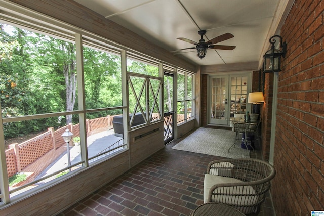 sunroom / solarium with french doors and ceiling fan