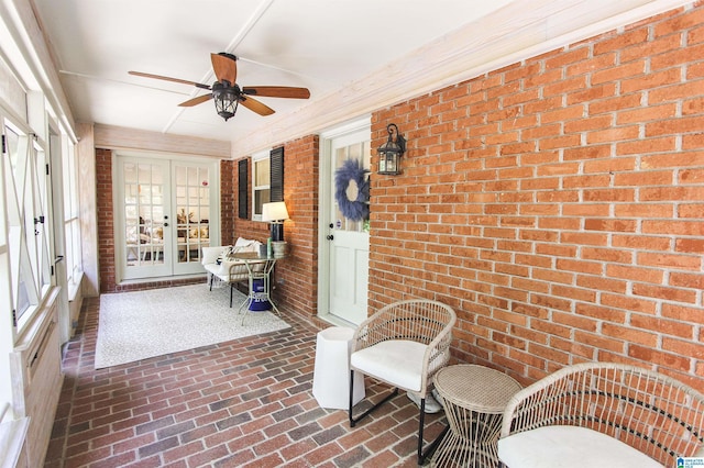 sunroom / solarium featuring french doors and ceiling fan