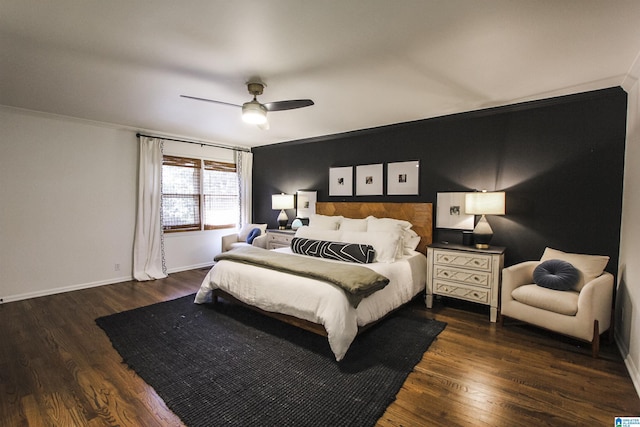 bedroom with ornamental molding, a ceiling fan, and wood finished floors