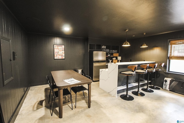dining space with wood walls