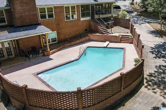5 Christopher Way, Anniston, AL 36207 - swimming pool featuring a sunroom, stairs, a patio, and a diving board