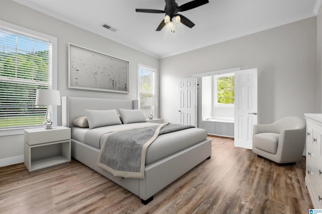 bedroom featuring visible vents, multiple windows, and light wood-type flooring