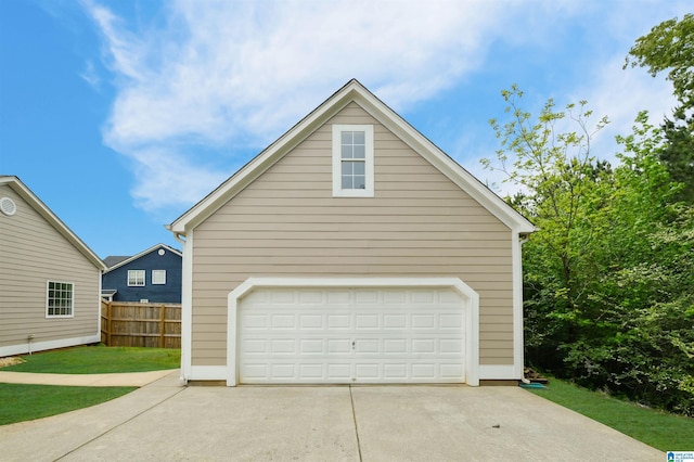 detached garage featuring fence