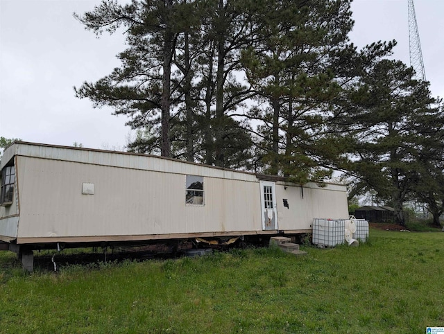 rear view of property featuring a lawn