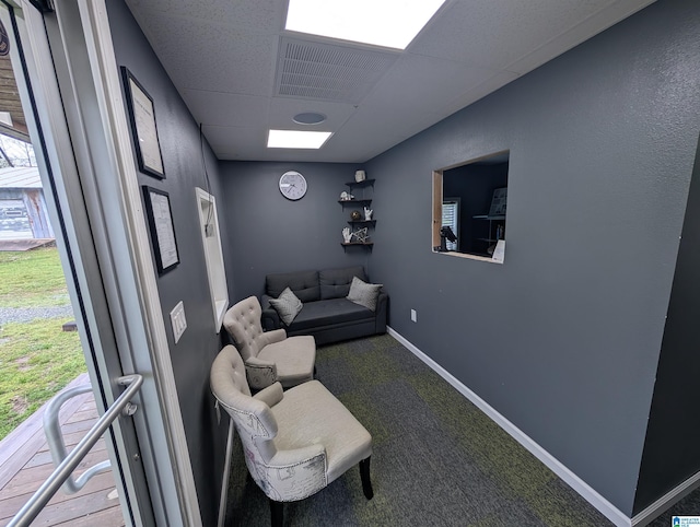 living area with carpet floors, baseboards, and visible vents