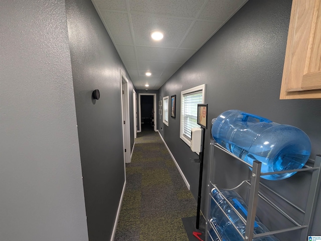 hallway featuring carpet flooring, recessed lighting, a textured wall, and baseboards