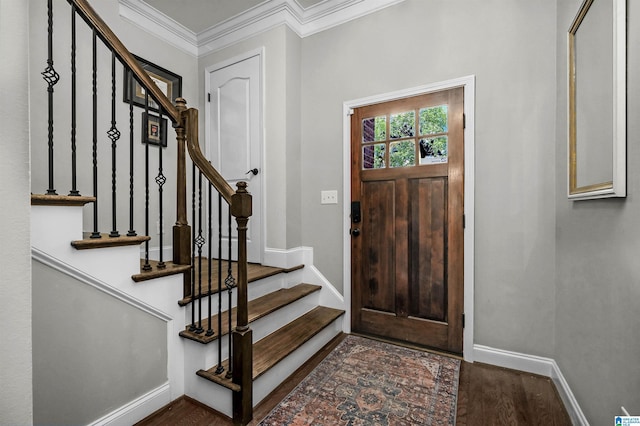 entrance foyer featuring baseboards, stairs, crown molding, and wood finished floors