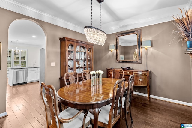 3057 Valley Ridge Rd, Hoover, AL 35242 - dining area featuring an inviting chandelier, arched walkways, baseboards, and wood finished floors