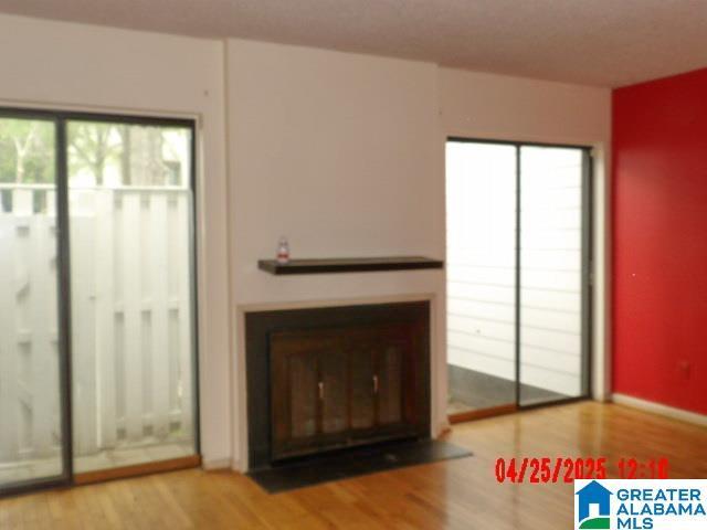 3821 Windhover Cir Unit 6, Vestavia Hills, AL 35216 - unfurnished living room featuring wood finished floors