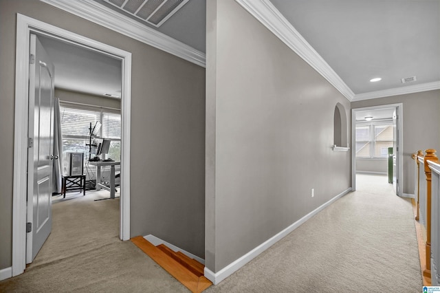 hallway with carpet flooring, baseboards, visible vents, and an upstairs landing