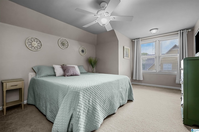 bedroom featuring baseboards, ceiling fan, lofted ceiling, and light colored carpet