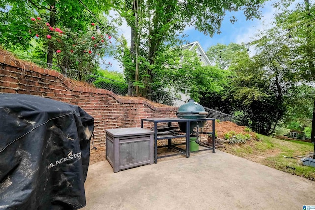 view of patio featuring fence and area for grilling