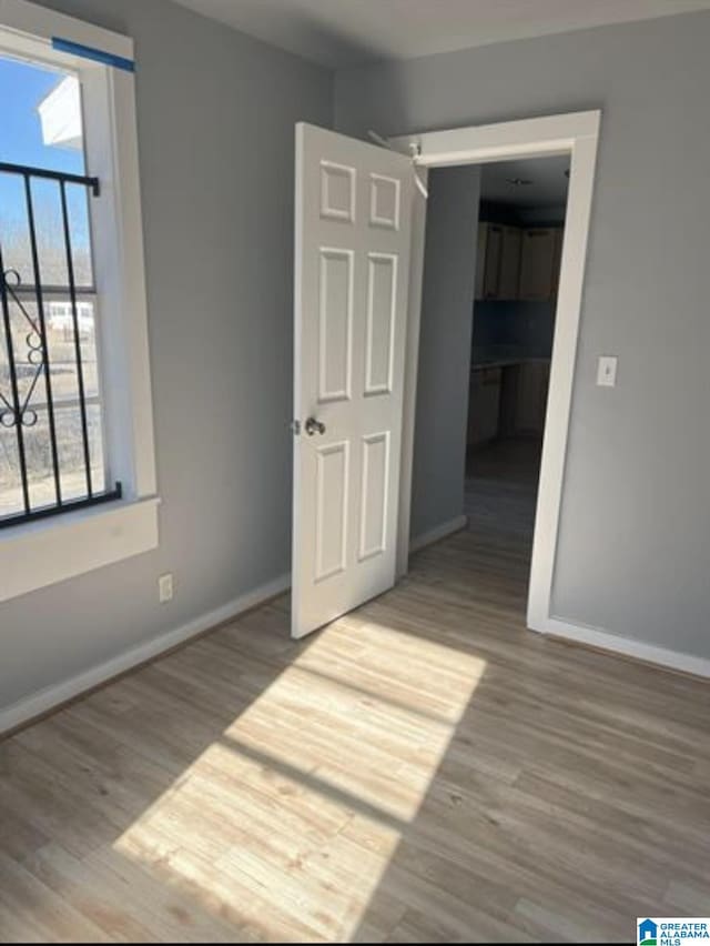 2129 Northland Ave SW, Birmingham, AL 35211 - unfurnished bedroom with baseboards and wood finished floors