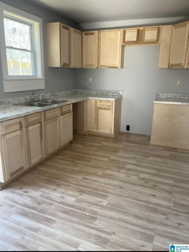 2129 Northland Ave SW, Birmingham, AL 35211 - kitchen with a sink, light countertops, light brown cabinetry, and light wood-style flooring