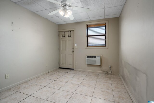 1212 12th St Unit 17, Tuscaloosa, AL 35401 - spare room featuring a wall mounted AC, a drop ceiling, light tile patterned flooring, ceiling fan, and baseboards