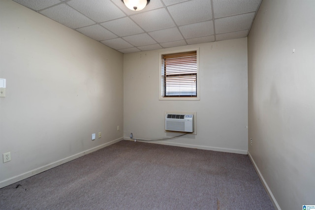 1212 12th St Unit 17, Tuscaloosa, AL 35401 - carpeted spare room with an AC wall unit, a paneled ceiling, and baseboards