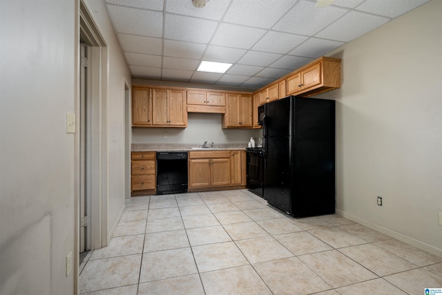 1212 12th St Unit 17, Tuscaloosa, AL 35401 - kitchen featuring black appliances, a drop ceiling, light countertops, a sink, and light tile patterned floors
