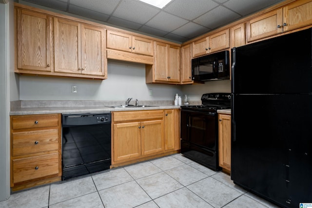 1212 12th St Unit 17, Tuscaloosa, AL 35401 - kitchen featuring black appliances, a sink, light countertops, and light tile patterned floors