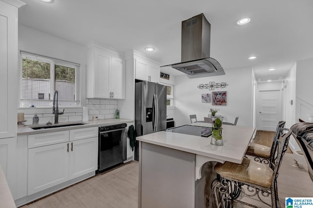 3824 Midway Rd, Adamsville, AL 35005 - kitchen with a kitchen bar, island range hood, light wood-type flooring, a sink, and black appliances