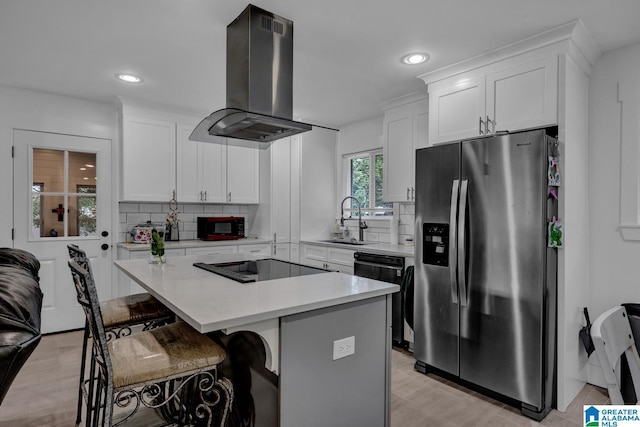 3824 Midway Rd, Adamsville, AL 35005 - kitchen featuring island exhaust hood, tasteful backsplash, a sink, light countertops, and black appliances