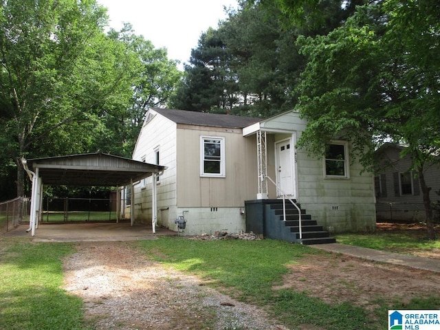 bungalow-style house featuring dirt driveway, fence, crawl space, and a carport