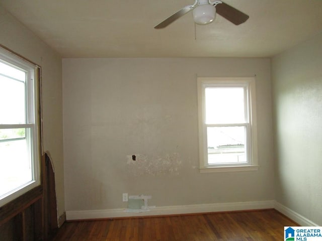 spare room featuring baseboards, ceiling fan, and wood finished floors