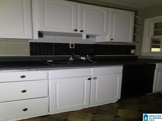 kitchen with a sink, decorative backsplash, white cabinets, and dark countertops