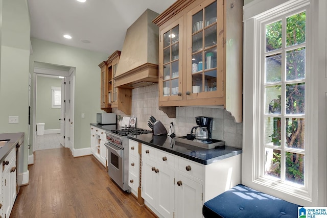 364 Stone Brook Cir, Hoover, AL 35226 - kitchen with high end stainless steel range oven, dark countertops, premium range hood, white microwave, and glass insert cabinets