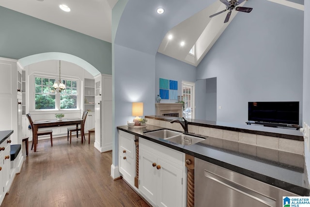 364 Stone Brook Cir, Hoover, AL 35226 - kitchen featuring dark countertops, arched walkways, dishwasher, a sink, and white cabinets