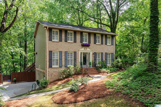 2017 Crossvine Rd, Hoover, AL 35244 - colonial house featuring brick siding, fence, driveway, and a chimney