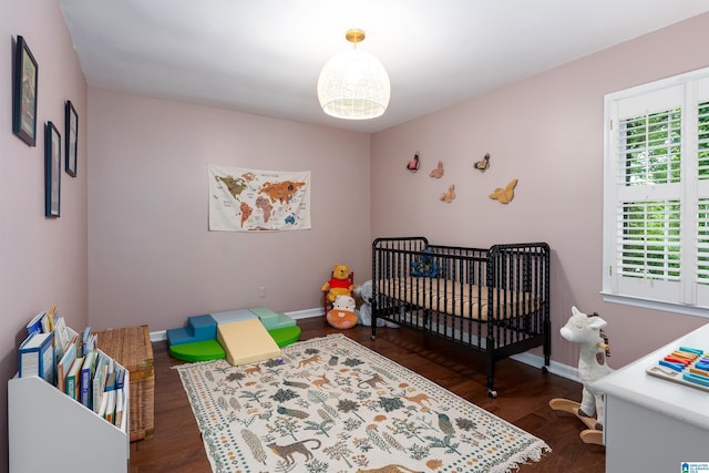 2017 Crossvine Rd, Hoover, AL 35244 - bedroom with dark wood-type flooring, a crib, and baseboards