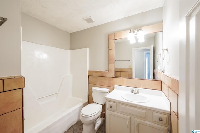full bath with a textured ceiling, visible vents, tile walls, vanity, and toilet