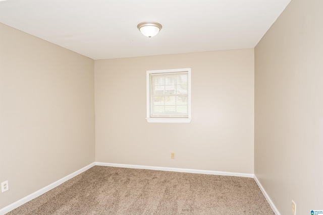 unfurnished room featuring baseboards and carpet flooring