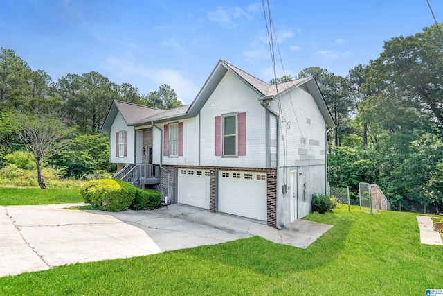view of front of home featuring concrete driveway, a front yard, and a garage