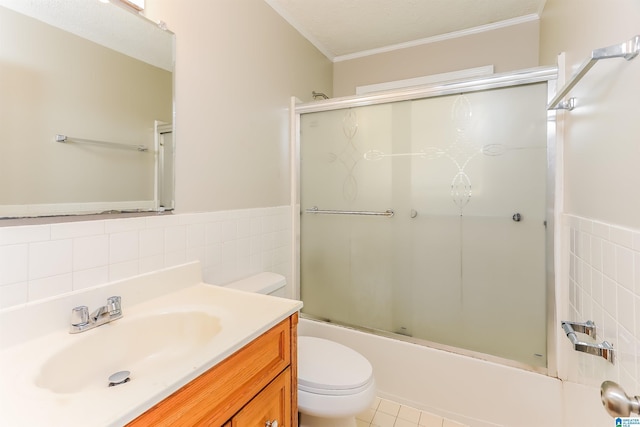 full bath with crown molding, vanity, toilet, enclosed tub / shower combo, and tile walls