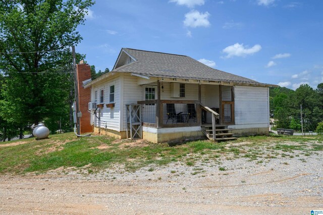 1352 County Road 185, Jemison, AL 35085 - view of front of house with a chimney, a porch, and a shingled roof
