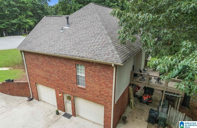107 Magnolia Ridge Cir, Chelsea, AL 35043 - view of property exterior featuring an attached garage, roof with shingles, driveway, and brick siding