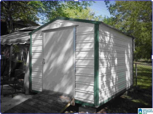 view of shed featuring fence