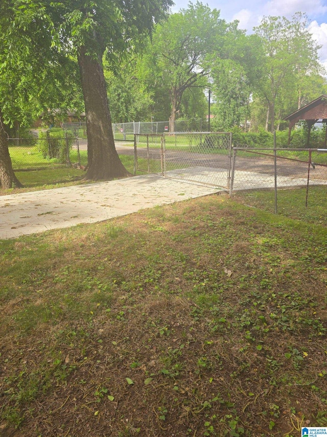 view of yard featuring fence and a gate