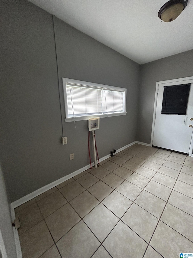 laundry area featuring laundry area, hookup for a washing machine, gas dryer hookup, baseboards, and light tile patterned floors