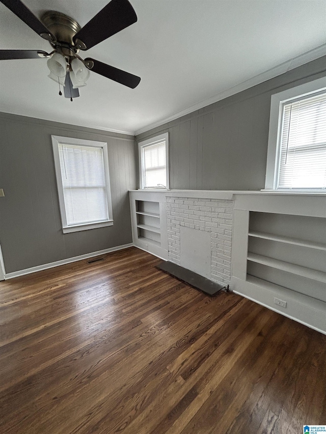 interior space featuring crown molding, ceiling fan, wood finished floors, and built in shelves