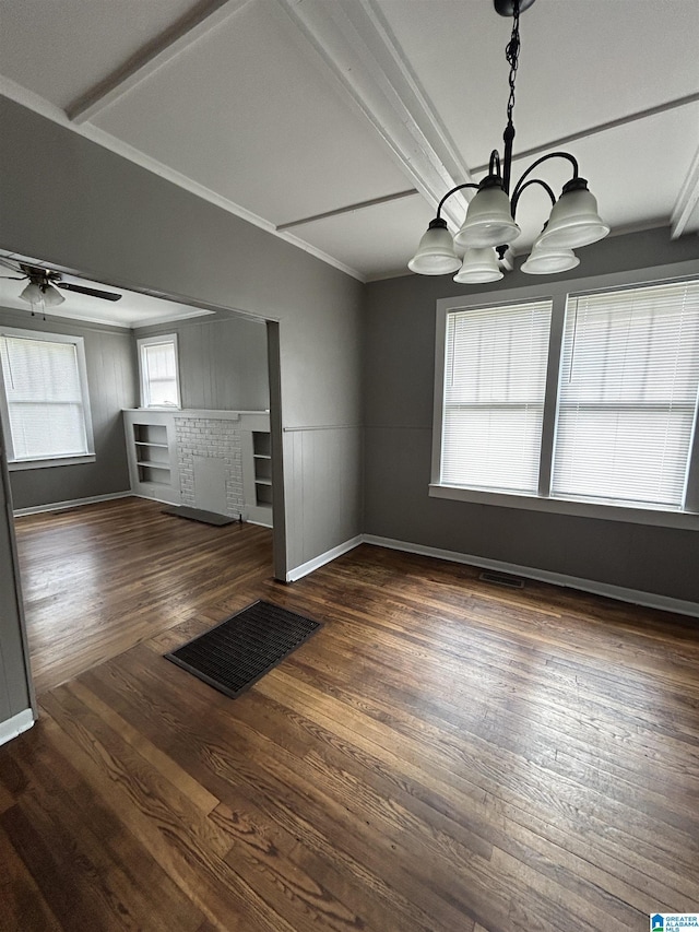 interior space with ceiling fan with notable chandelier, baseboards, wood finished floors, visible vents, and ornamental molding