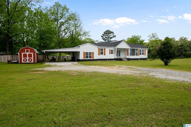 2857 Alexandria Wellington Rd, Alexandria, AL 36250 - view of front of house with a storage shed, a front yard, an outbuilding, a carport, and driveway