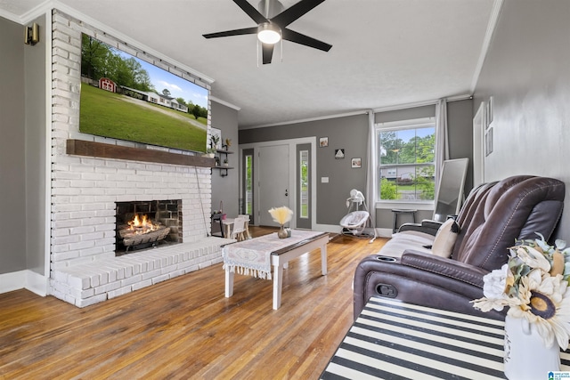 2857 Alexandria Wellington Rd, Alexandria, AL 36250 - living room with ornamental molding, a brick fireplace, wood finished floors, baseboards, and a ceiling fan