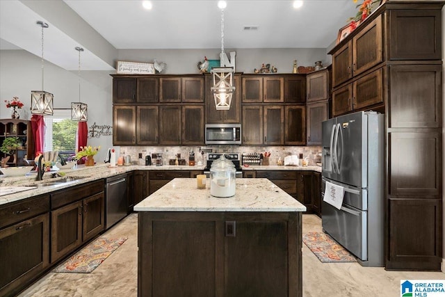 kitchen featuring dark brown cabinets, appliances with stainless steel finishes, a sink, decorative backsplash, and visible vents