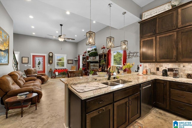 kitchen with dark brown cabinets, a high ceiling, a sink, a peninsula, and stainless steel dishwasher