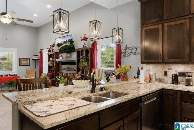 kitchen featuring a sink, dishwasher, and dark brown cabinetry
