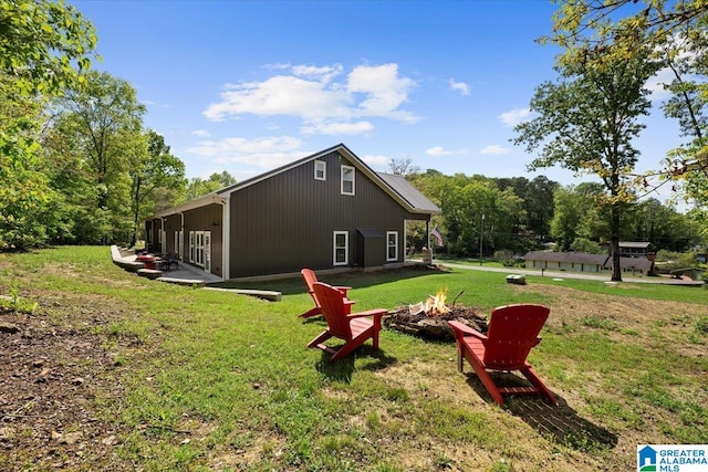 exterior space featuring a yard and an outdoor fire pit