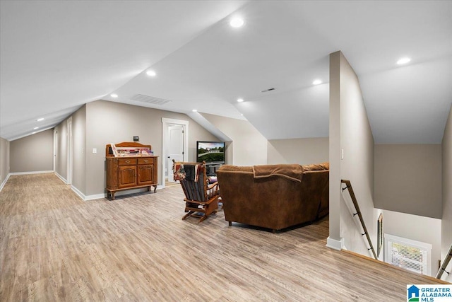 bonus room with baseboards, visible vents, light wood-style flooring, and lofted ceiling
